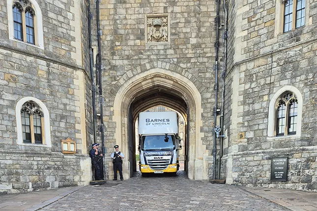 Careful handling up a narrow spiral staircase across four storeys, with protection for centuries-old surfaces.